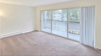 Living Room and Patio Slider | The Encore Apartments in Lynwood, WA 98036